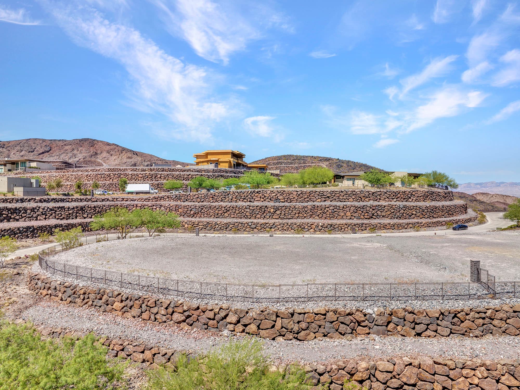Elevated homesite showcasing Ascaya’s signature terraced stone walls, desert terrain, and surrounding mountain views.