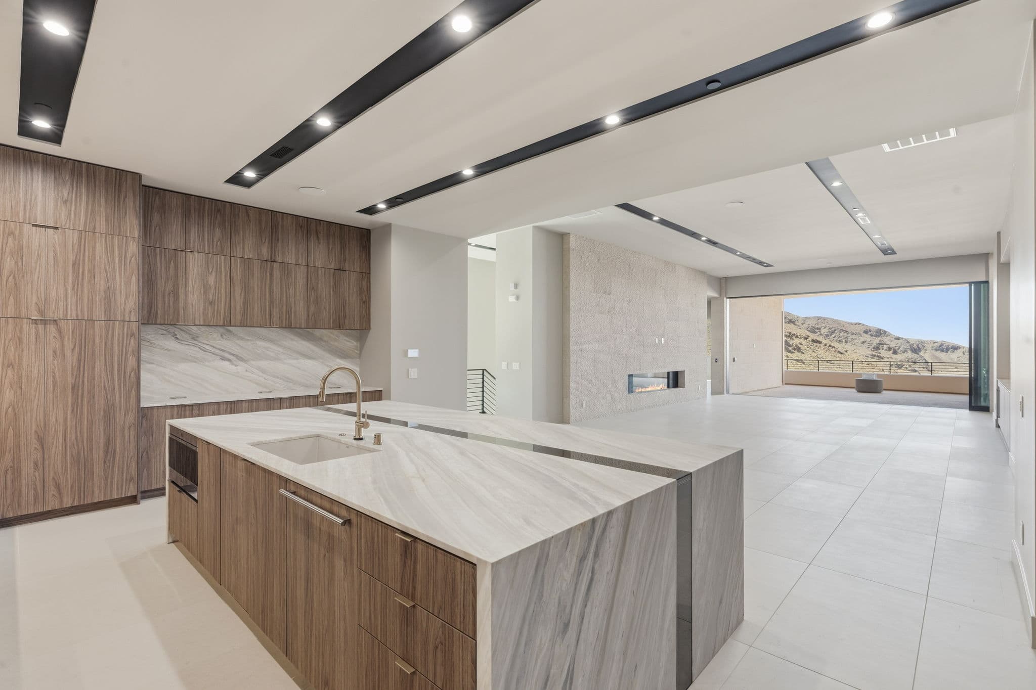 Modern luxury residence with contemporary architecture, open-concept living spaces, high-end finishes, expansive windows, and seamless indoor-outdoor design set against scenic desert mountain views.