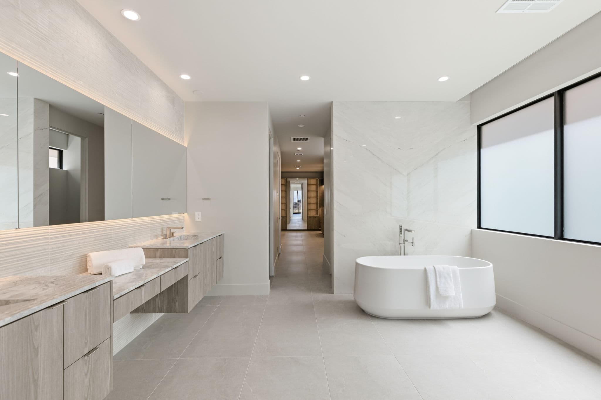 Modern luxury residence with contemporary architecture, open-concept living spaces, high-end finishes, expansive windows, and seamless indoor-outdoor design set against scenic desert mountain views.