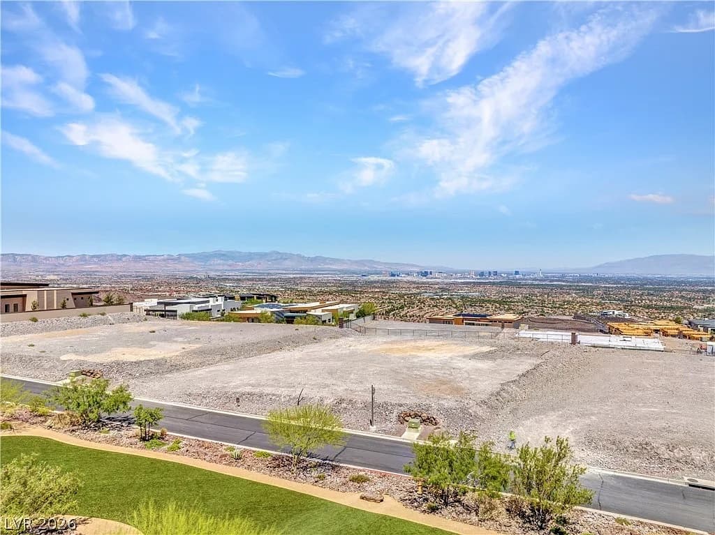 Estate homesite at Ascaya bordered by dramatic desert rock formations and neighboring contemporary custom homes.