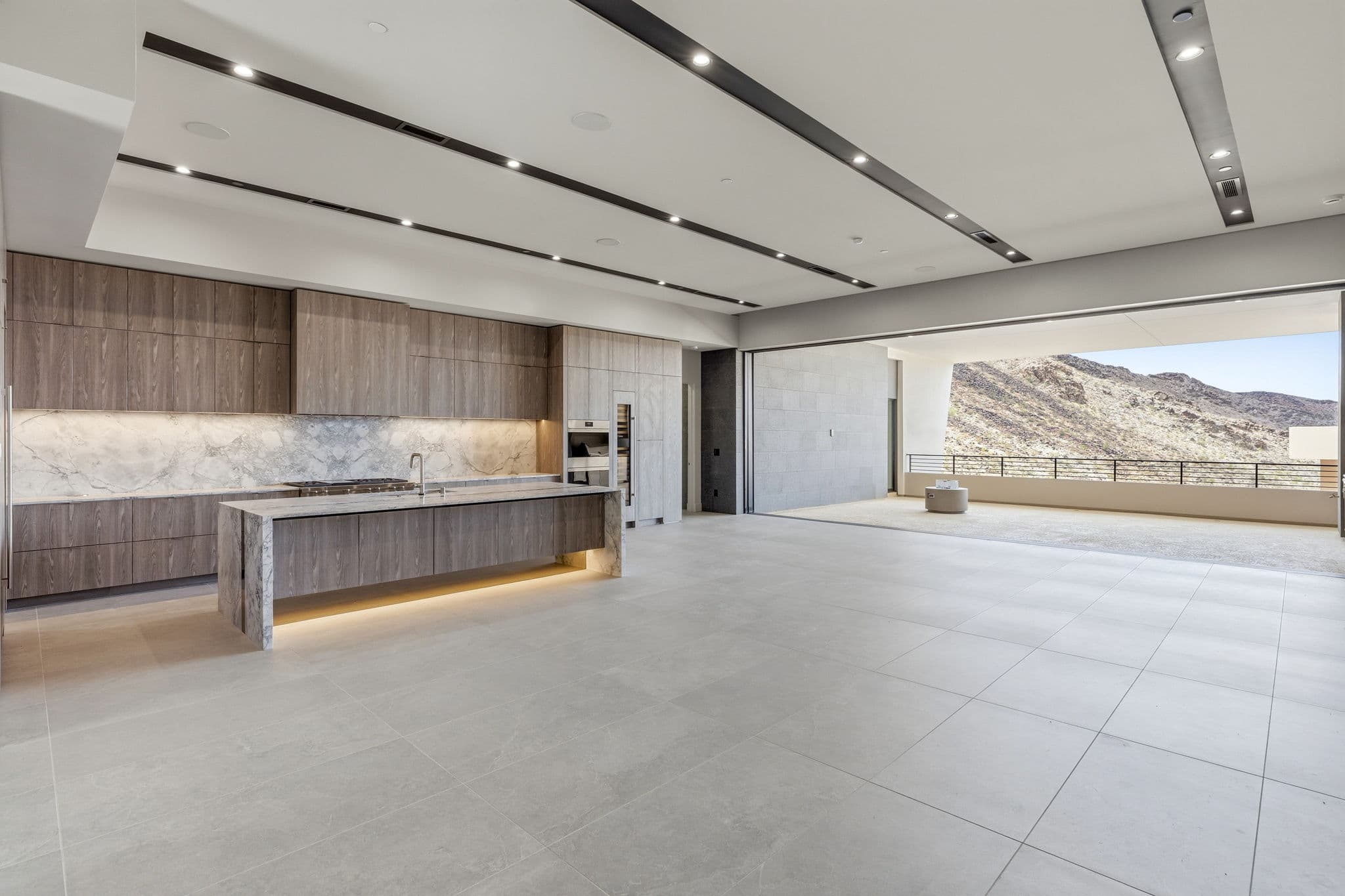 Modern luxury residence with contemporary architecture, open-concept living spaces, high-end finishes, expansive windows, and seamless indoor-outdoor design set against scenic desert mountain views.