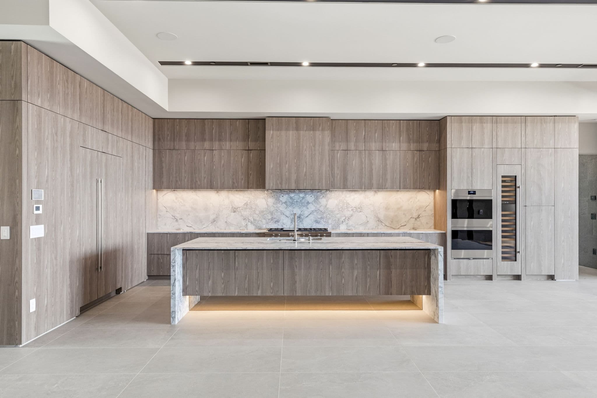 Modern luxury residence with contemporary architecture, open-concept living spaces, high-end finishes, expansive windows, and seamless indoor-outdoor design set against scenic desert mountain views.