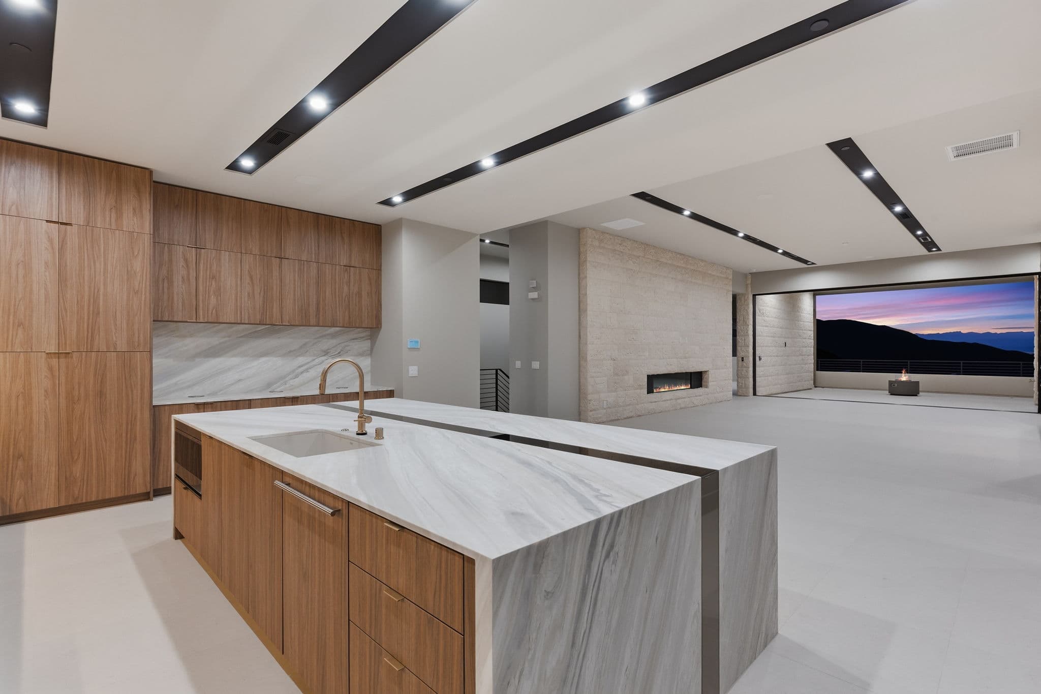 Modern luxury residence with contemporary architecture, open-concept living spaces, high-end finishes, expansive windows, and seamless indoor-outdoor design set against scenic desert mountain views.