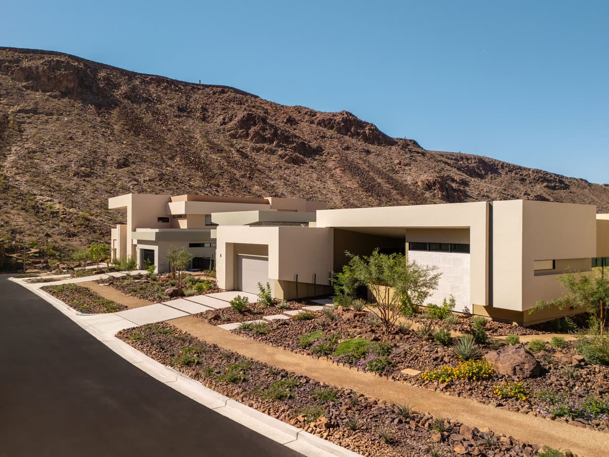 Contemporary desert homes with minimalist architecture, landscaped xeriscape gardens, and scenic mountain backdrop in a luxury residential community.