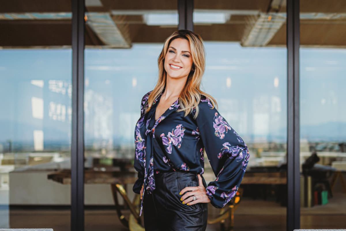 Real estate professional posing inside luxury home.