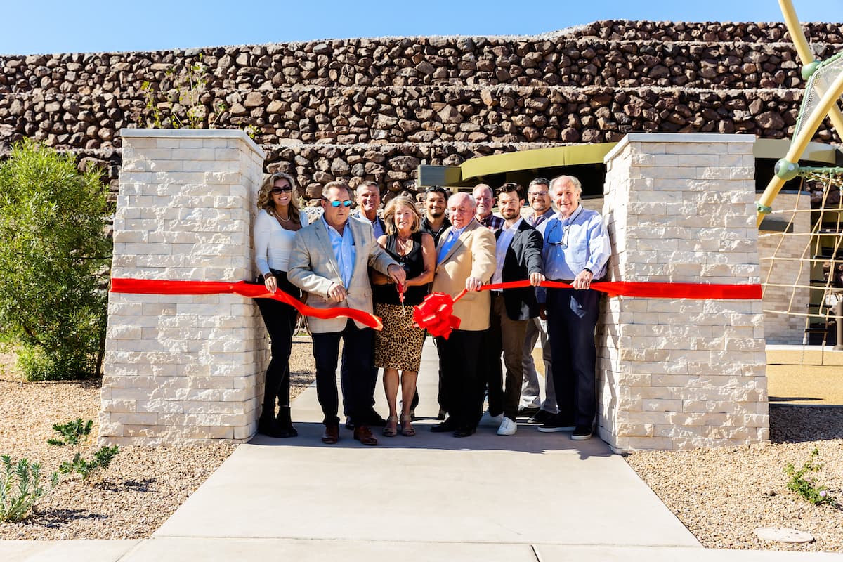 Ribbon cutting ceremony at new luxury residential development.