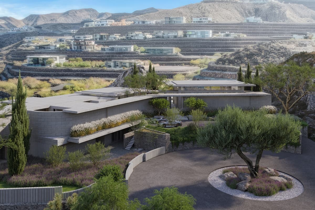 Modern terraced hillside community with luxury homes, desert landscaping, and a circular driveway in the foreground.