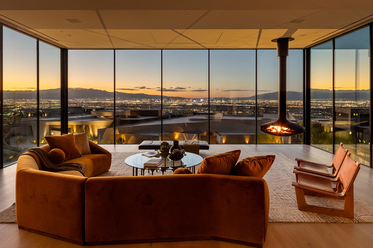 Contemporary Ascaya living room with panoramic Las Vegas Strip views and suspended fireplace