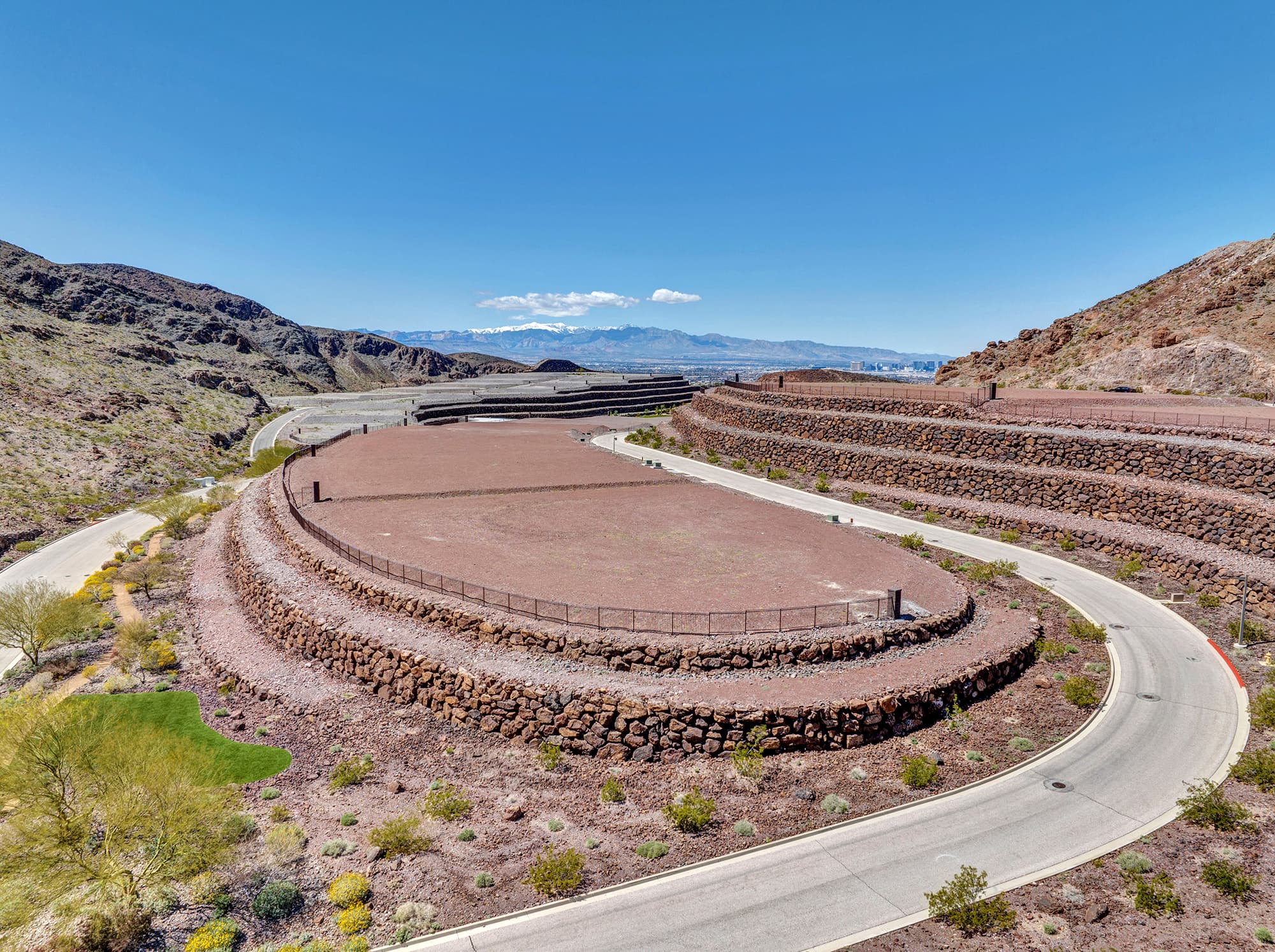 Aerial view of homesite lot outlined within a desert mountainside community development