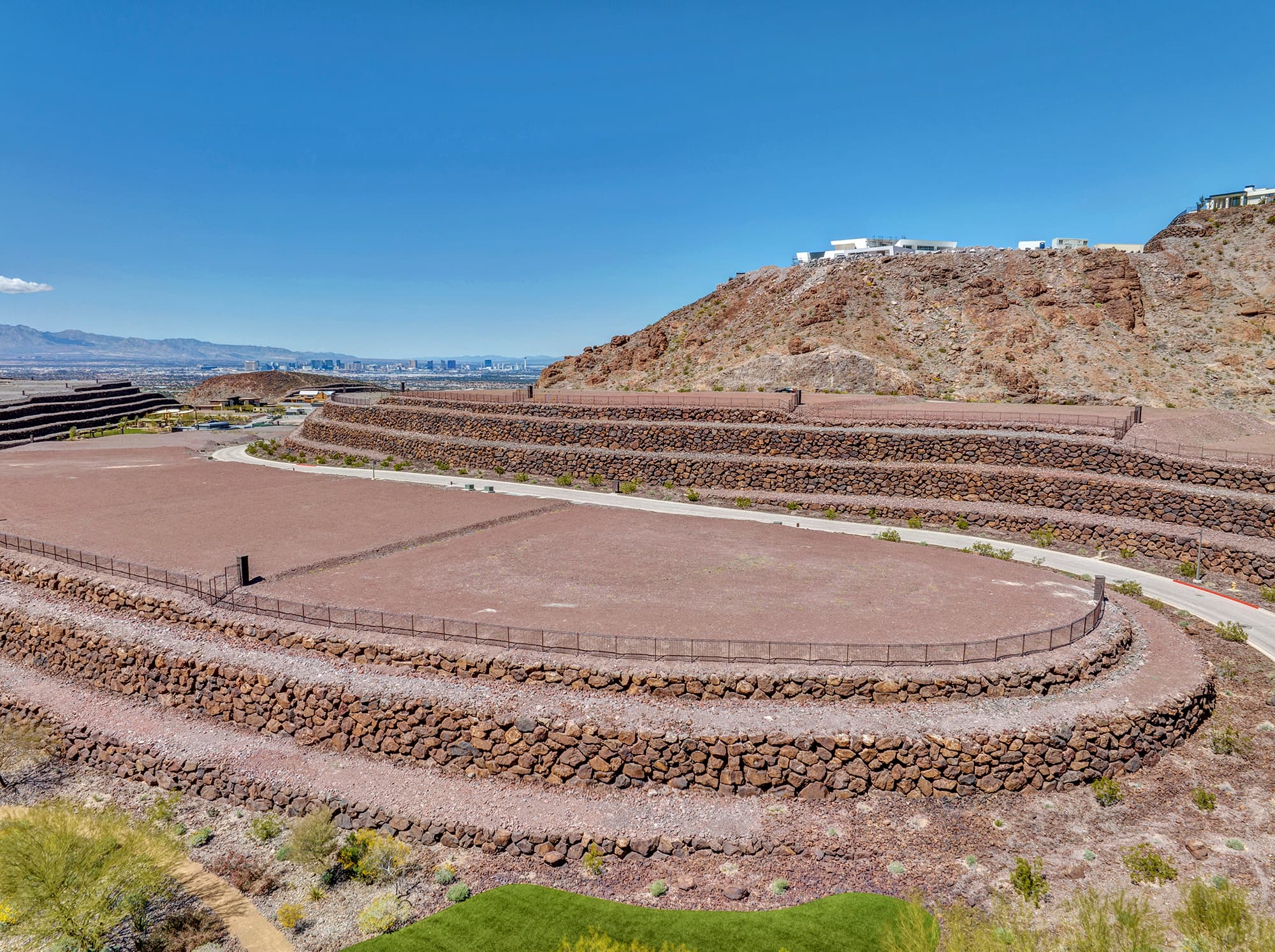 Aerial view of homesite lot outlined within a desert mountainside community development